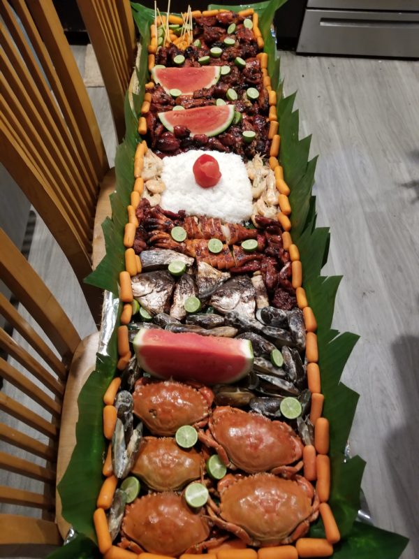 Boodle fight tray seafood and bbq